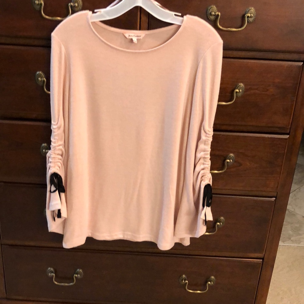 Juicy Courure light pink color never worn. Black ties on sleeves. Sz small